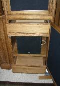 Front left speaker with a drawerabove and a slilde out shelf below.