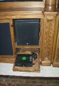 One of the subwoofers, slide out shelf for game station.