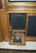 One of the subwoofers, slide out shelf for game station.